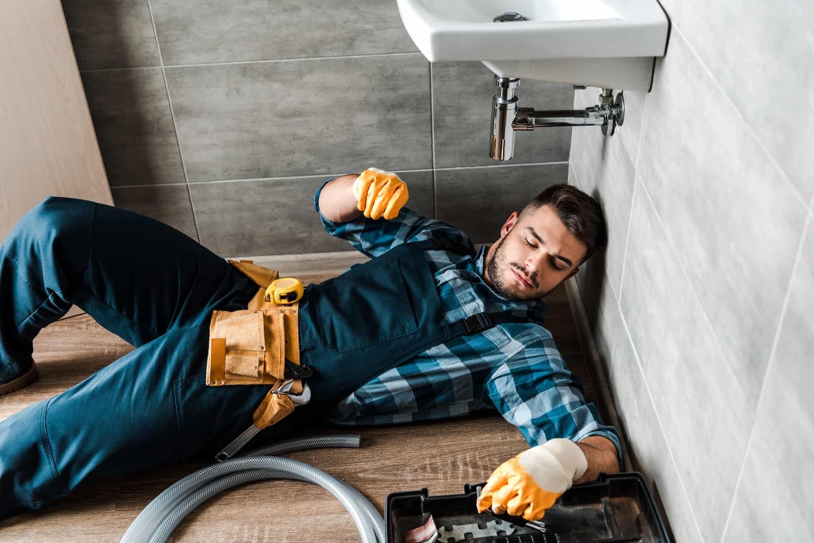 bearded-handyman-lying-on-floor-near-toolbox-in-bathroom.jpg bearded-handyman-lying-on-floor-near-toolbox-in-bathroom.jpg